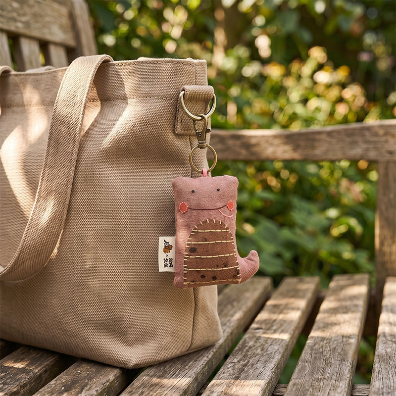 Handgefertigter rosa-schwanzgestreifter Schlangen-Taschenanhänger aus Leinen – side view showing shape and hand-stitched details