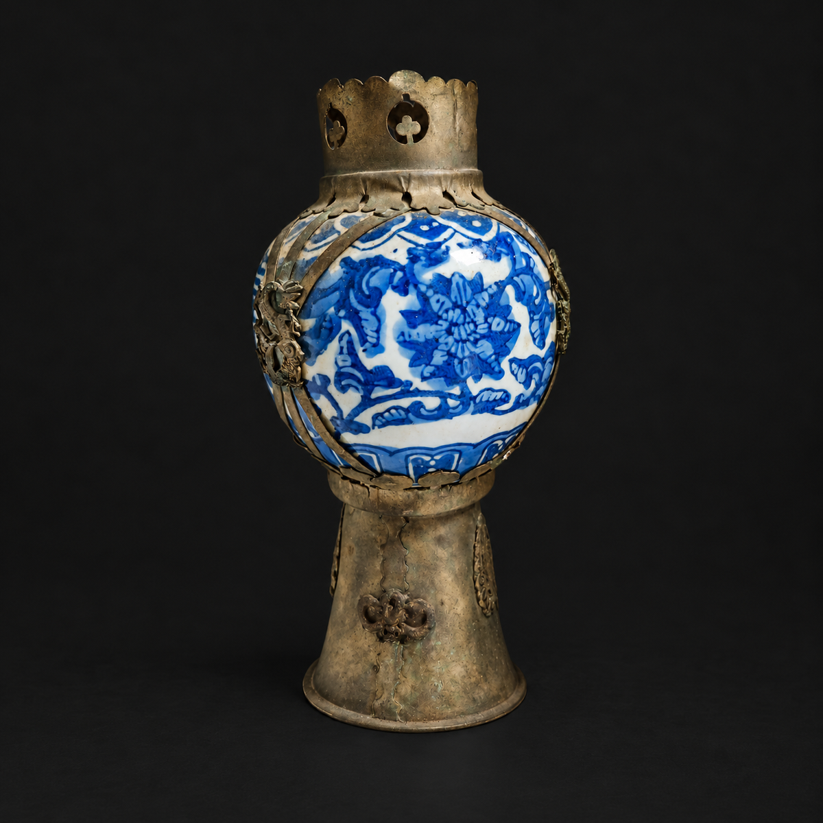 Rear view showing porcelain floral decoration and metal foot seam