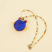 Red Spirit Pendant - Blue Ground – side view showing shape and hand-stitched details