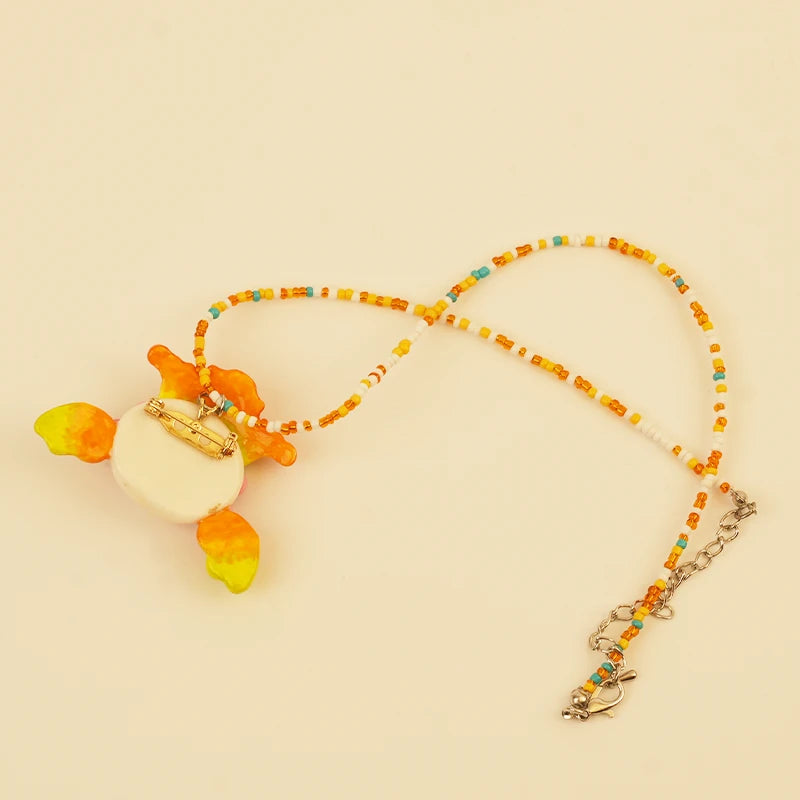 Forest Sprite Spirit Pendant - Orange and Green – side view showing shape and hand-stitched details