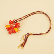 Sun Spirit Pendant - Red Braided Cord – close-up of linen, patchwork, and textile texture
