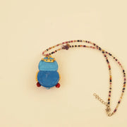 Forest Sprite Spirit Pendant - Blue and Gold Leaves – side view showing shape and hand-stitched details